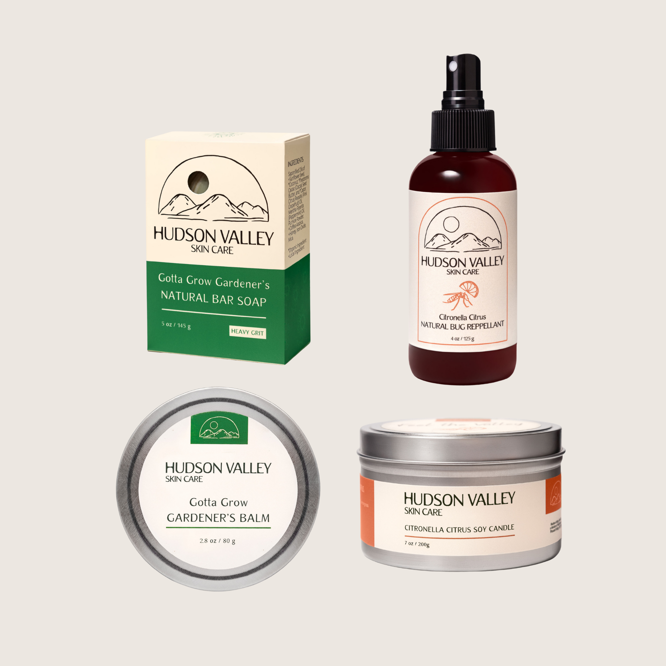 Collection of Hudson Valley Skin Care garden products including a bar soap, balm, candle, and spray bottle on a light beige background.